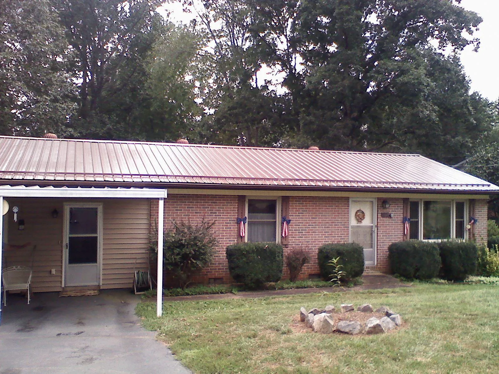 Bronze metal roof and carport on a brick ranch home — Roof Repair work by our crew in Society Hill